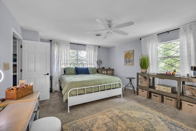 bedroom featuring dark colored carpet and ceiling fan