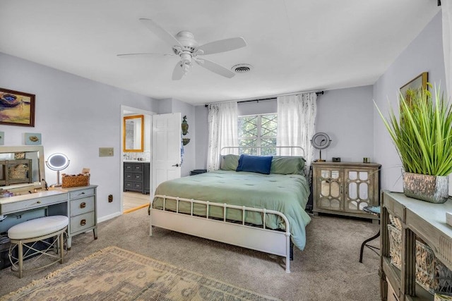 carpeted bedroom featuring ceiling fan and ensuite bathroom