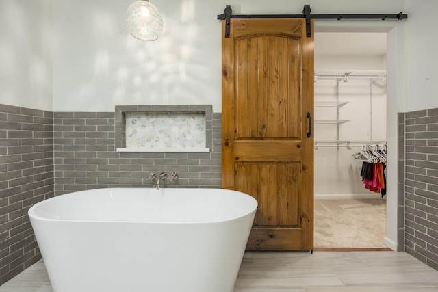 bathroom featuring brick wall and a tub