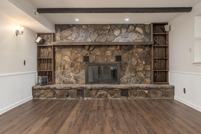 details featuring beam ceiling, hardwood / wood-style flooring, and a stone fireplace