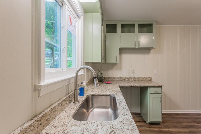 kitchen featuring green cabinetry, light stone countertops, sink, and dark hardwood / wood-style flooring