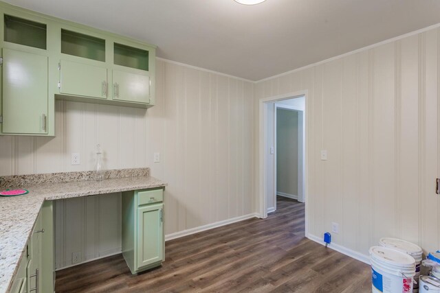 kitchen featuring ornamental molding, green cabinets, light stone counters, and dark hardwood / wood-style floors