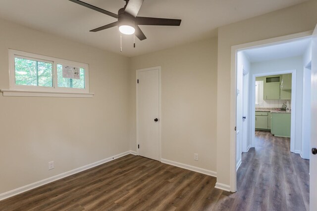 unfurnished bedroom with dark hardwood / wood-style flooring and ceiling fan