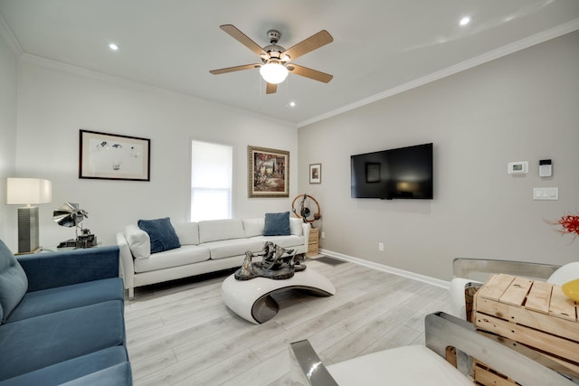 living room with light hardwood / wood-style flooring, ceiling fan, and ornamental molding