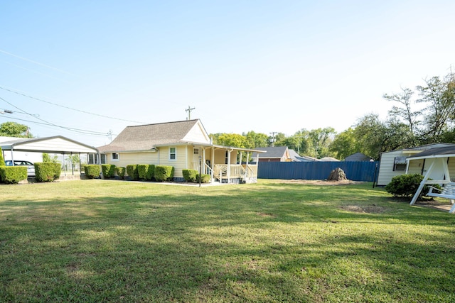 view of yard featuring a porch and a carport