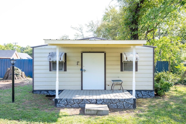 back of property with a yard and a wooden deck