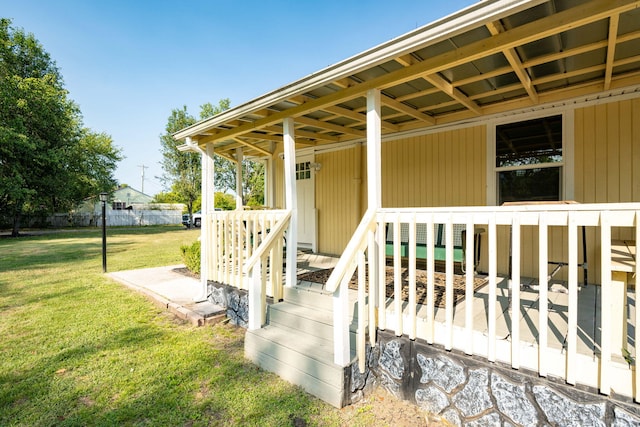 entrance to property featuring a yard