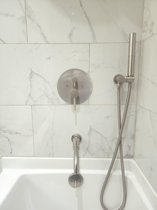 room details with tiled shower and sink