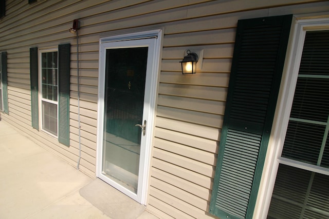 exterior space featuring wood walls and tile patterned floors