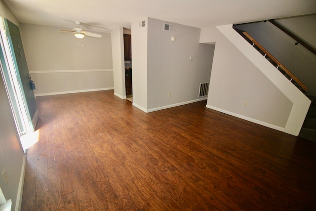 unfurnished living room with dark wood-type flooring and ceiling fan