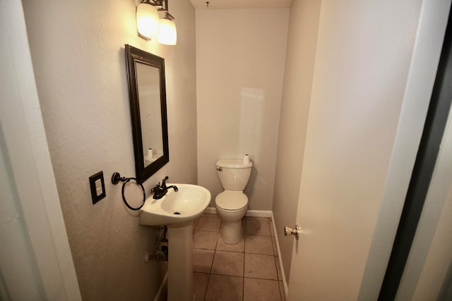 bathroom with tile patterned flooring, sink, and toilet