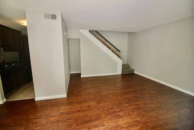 empty room featuring sink and hardwood / wood-style flooring