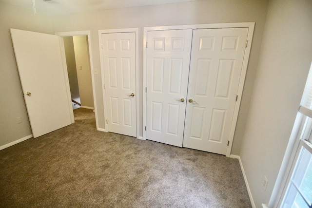 unfurnished bedroom featuring carpet floors and multiple closets