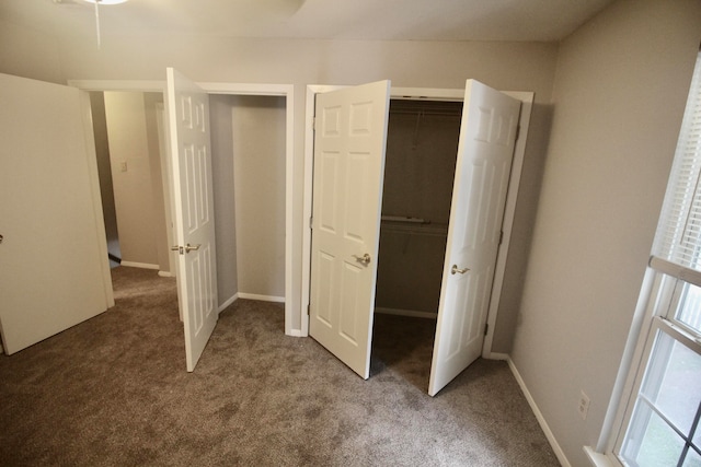 unfurnished bedroom with a closet and carpet