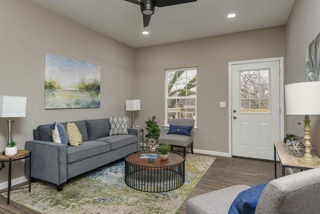 living room featuring hardwood / wood-style floors and ceiling fan