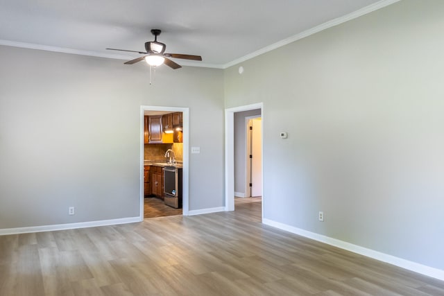 unfurnished bedroom with ceiling fan, connected bathroom, sink, light hardwood / wood-style flooring, and crown molding