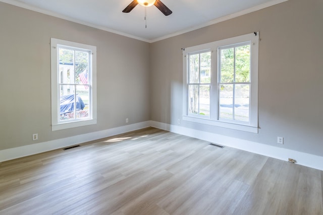 empty room featuring ceiling fan, light wood-type flooring, and crown molding