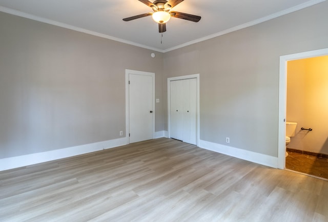 unfurnished bedroom with light wood-type flooring, ornamental molding, ensuite bath, and ceiling fan