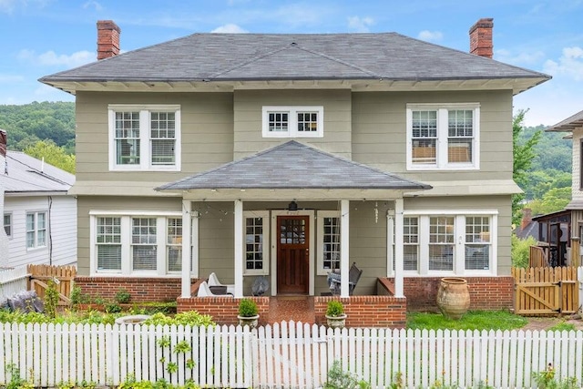 back of property with covered porch