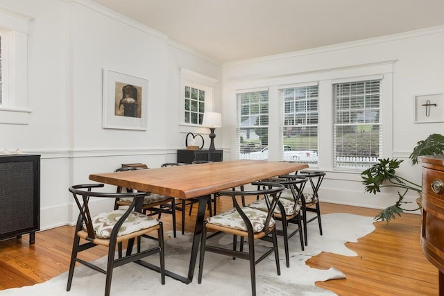 dining space featuring light hardwood / wood-style flooring and ornamental molding