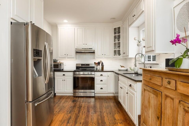 kitchen featuring appliances with stainless steel finishes, white cabinetry, and sink