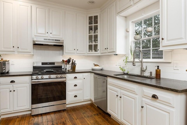 kitchen featuring appliances with stainless steel finishes, white cabinetry, sink, and dark hardwood / wood-style floors