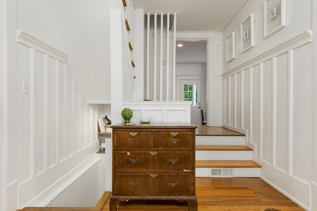 stairs featuring wood-type flooring