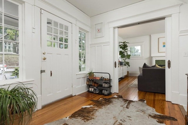 entryway featuring ornamental molding, radiator, and hardwood / wood-style flooring