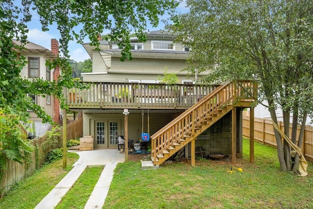 rear view of property featuring a yard, a patio area, a wooden deck, and french doors