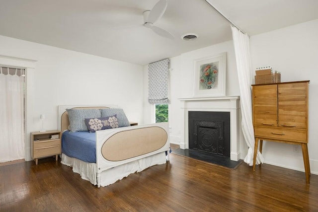 bedroom with ceiling fan and dark wood-type flooring