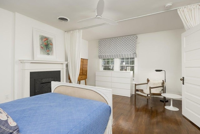 bedroom with ceiling fan and dark hardwood / wood-style flooring