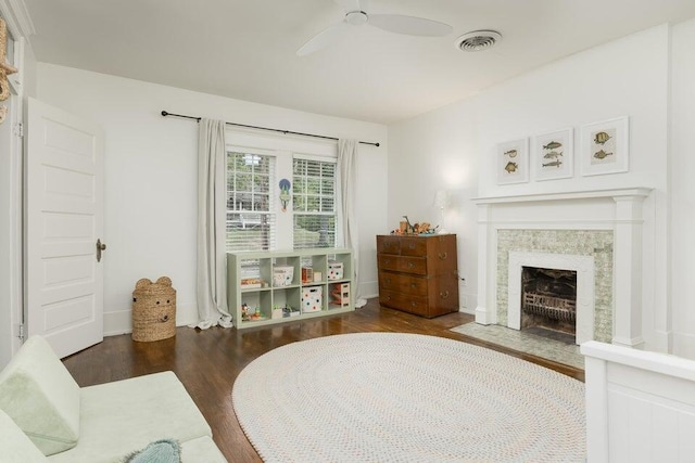 living area featuring ceiling fan and dark hardwood / wood-style floors