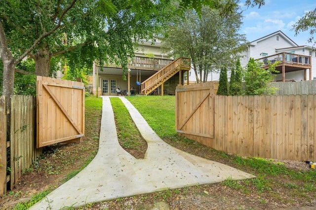 view of yard with a wooden deck and french doors