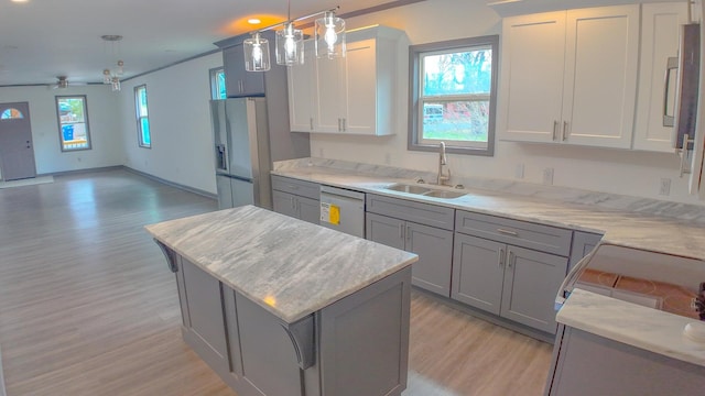 kitchen featuring plenty of natural light, pendant lighting, and a breakfast bar area