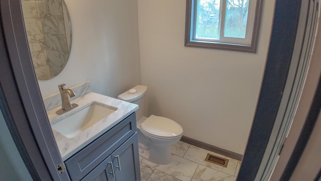 bathroom featuring toilet and vanity