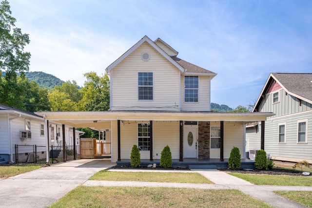 view of front of home featuring a porch and a carport