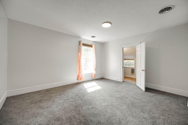 unfurnished bedroom with a textured ceiling and carpet