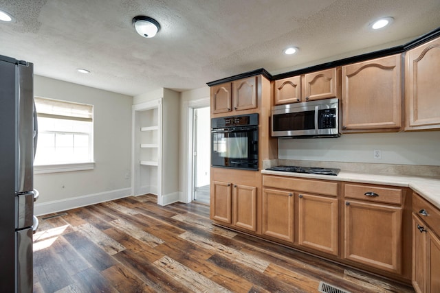 kitchen with black appliances, a textured ceiling, and dark wood-type flooring