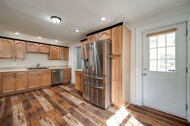 kitchen featuring a textured ceiling, stainless steel appliances, sink, and dark hardwood / wood-style flooring