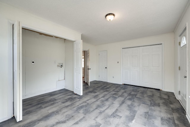 unfurnished bedroom with hardwood / wood-style flooring and a textured ceiling