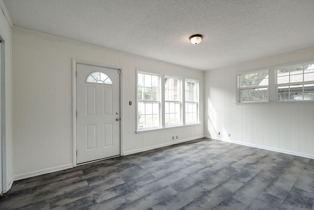 entryway featuring dark wood-type flooring and a textured ceiling