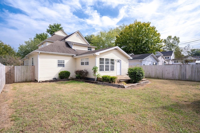 rear view of house with a yard