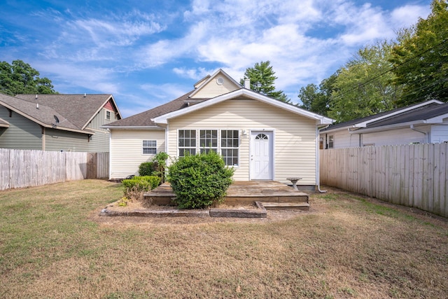 back of house featuring a yard