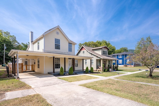 view of front of home with a porch, a carport, and a front lawn