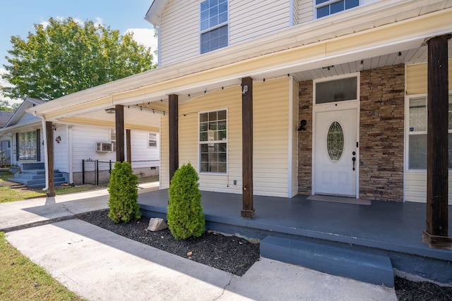 entrance to property featuring cooling unit and a porch