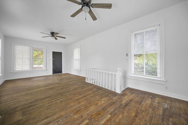 empty room with ceiling fan and dark wood-type flooring