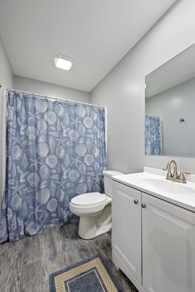 bathroom with wood-type flooring, a shower with curtain, vanity, and toilet