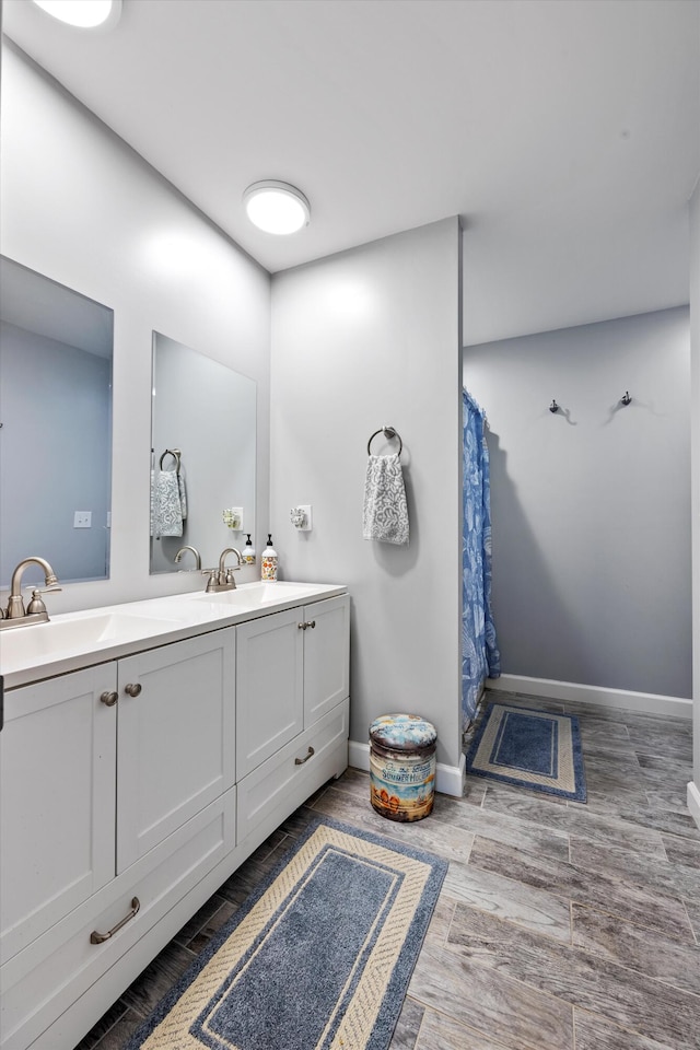 bathroom featuring a shower with shower curtain, hardwood / wood-style flooring, and vanity