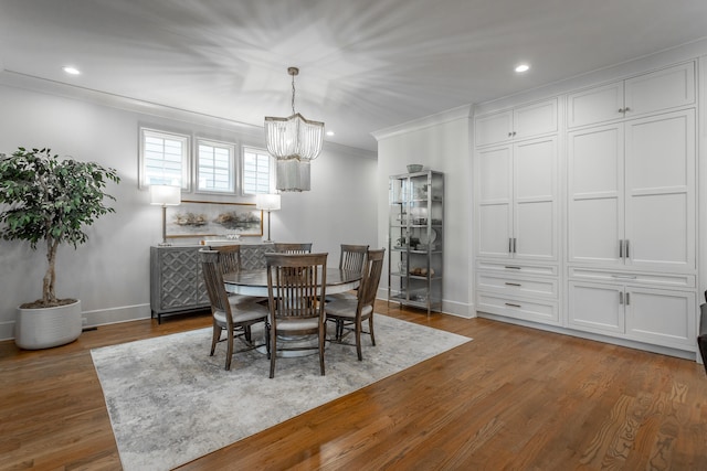 dining area featuring a chandelier, dark hardwood / wood-style flooring, and ornamental molding