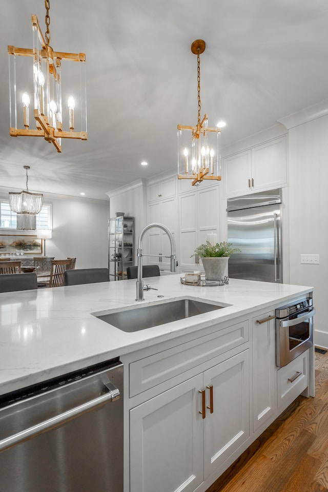 kitchen with pendant lighting, stainless steel appliances, dark hardwood / wood-style flooring, and sink